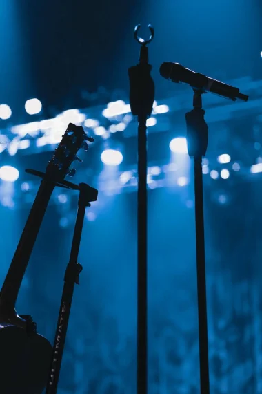 Microphone stands set up on a stage.